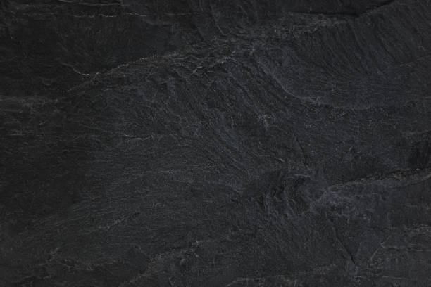 istock Dark grey black slate background or natural black stone texture. 1159725898