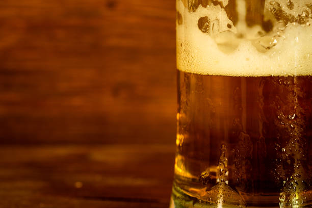istock glass of beer with foam 1159726892