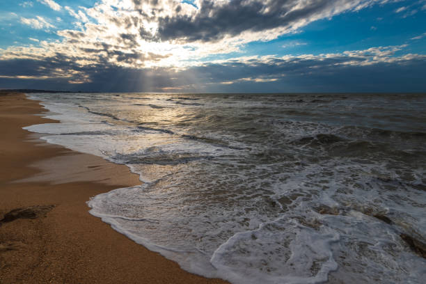 istock A beach with golden sand, small waves and a beautiful dramatic sky 1159727810