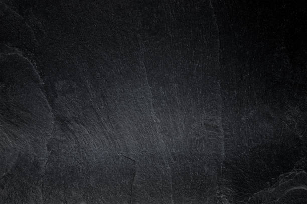 istock Dark grey black slate background or natural black stone texture. 1159728497