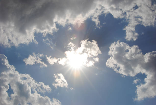 istock The sun in the blue sky with clouds. Natural phenomenon 1159728550