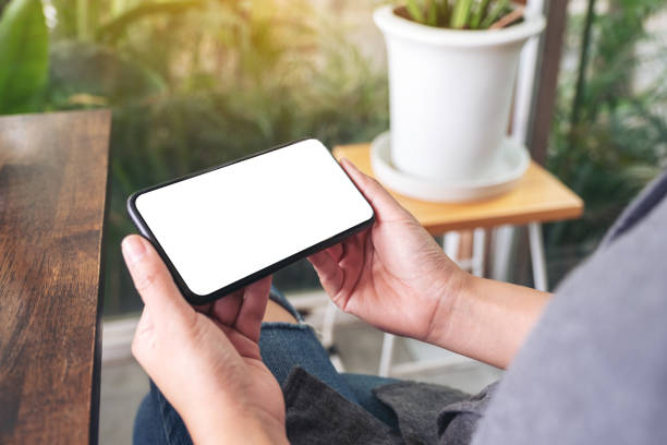 istock a woman holding and using black mobile phone with blank desktop screen 1159732057