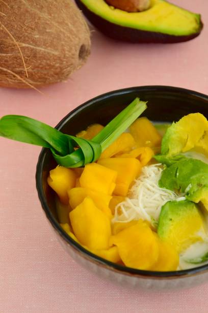 istock Es Teler, fruit cocktail from Indonesia. Avocado, coconut meat and jackfruit served with shaved ice, coconut milk, sweetened condensed milk, syrup. 1159736148