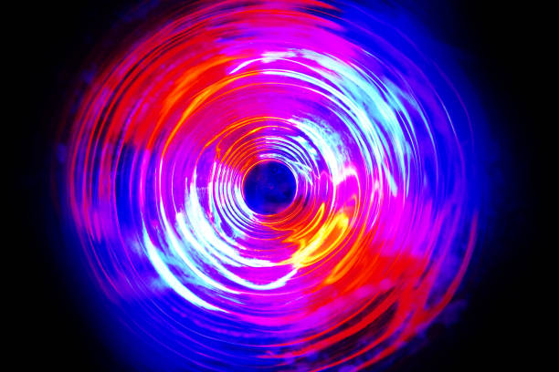 istock LED violet and blue light spinning in the dark. 1159736246