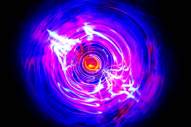 istock LED violet and blue light spinning in the dark. 1159736258