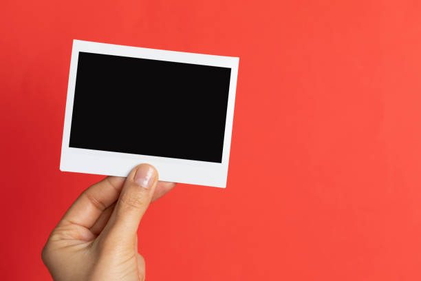 istock Hand Holding Instant Photo 1159737802