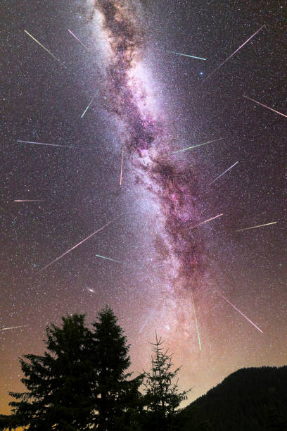 istock Purple Milky way falling stars pine trees silhouette 1159737929