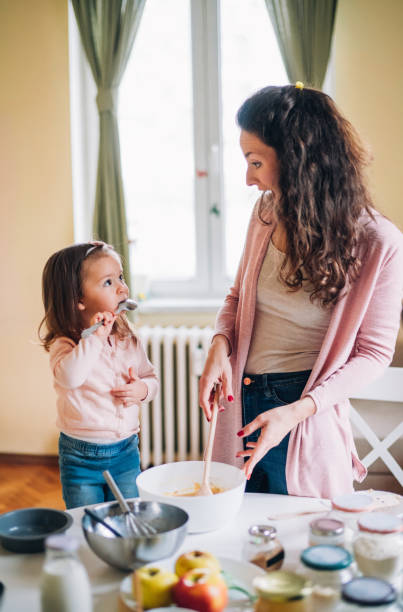istock Happy mother and daughter in kitchen 1159740374