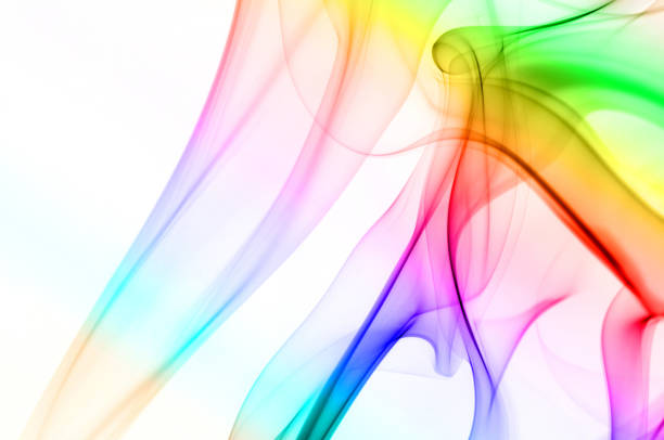 Colored smoke consisting of a color gradient from yellow to green to aqua to blue and finally to red on a white background. The figure is shapeless with a soft focus and is intertwined with black shadows. The Image is centered on the right hand side.