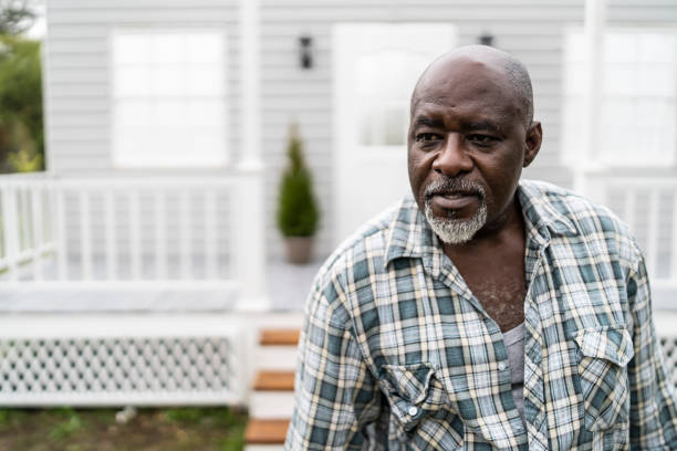 istock Mature african man standing outdoors in front yard 1159741173