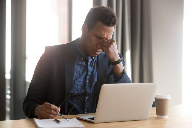 istock Tired black businessman take off glasses suffering from headache 1159741257