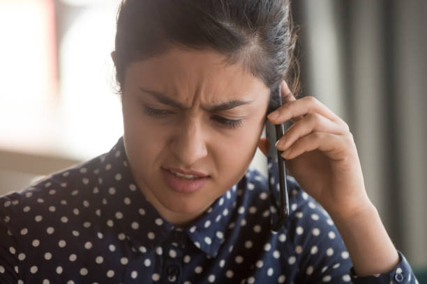 istock Female indian employee having unpleasant cellphone conversation 1159741271
