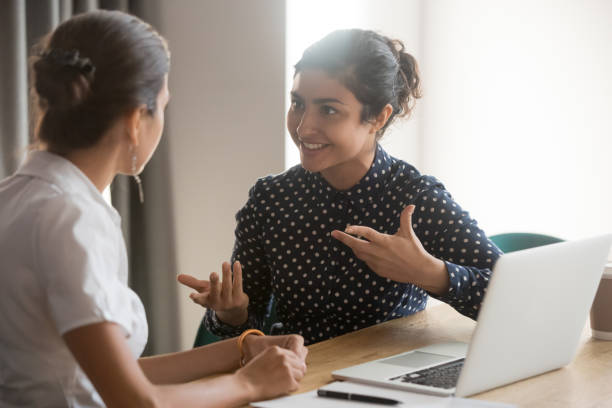 istock Excited diverse female colleagues discuss ideas at workplace 1159741279