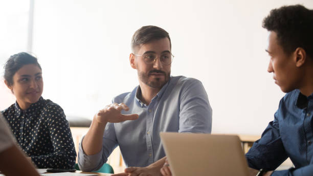 istock Diverse colleagues talk discussing ideas during meeting in office 1159741287