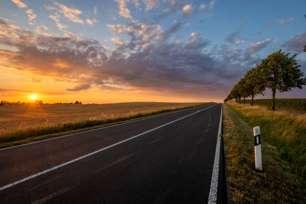 istock asphalt road in Germany during a beautiful summer sunset 1159742214
