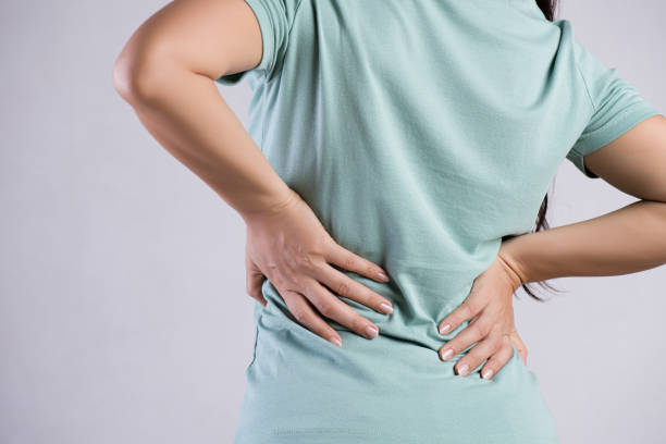 close up woman having pain in injured back. healthcare and back pain concept. - inflammation back physical therapy isolated on white imagens e fotografias de stock