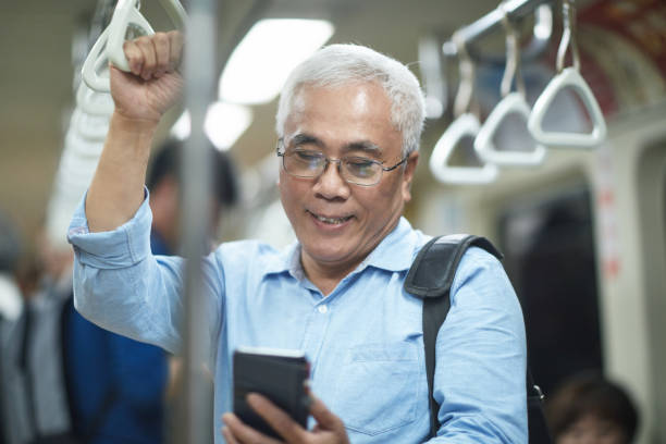istock Working Senior Asian Man Riding Subway into Downtown Taipei 1159742374