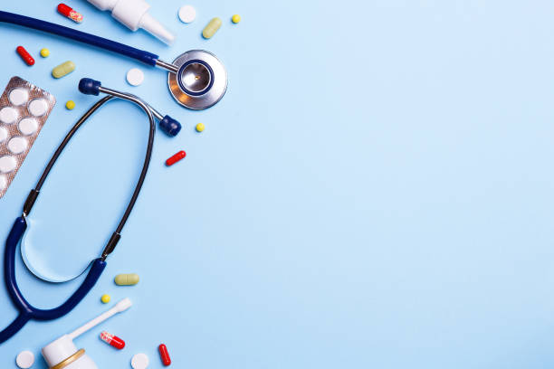 istock Cold medicine and phonendoscope on a blue background. 1159744927