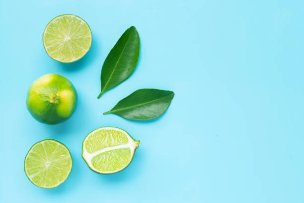 istock Limes with leaves on blue background. 1159745112