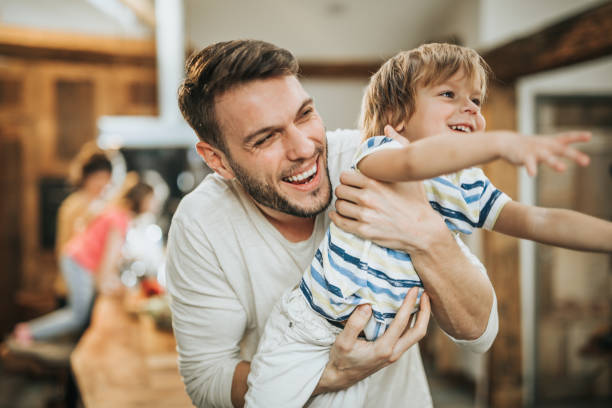 istock Joyful father having fun with his small son at home. 1159746677