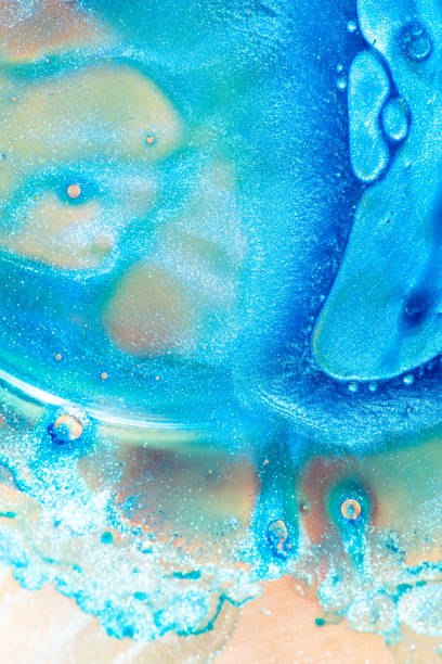 istock Macro shot suspension of particles in a colored emulsion over backlit background 1159747704