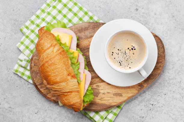 istock Coffee and croissant sandwich 1159748236
