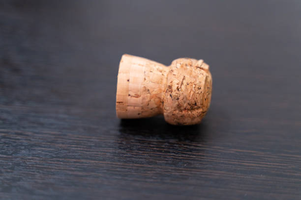 istock Cork from champagne or wine on a dark wooden table close-up. 1159749347