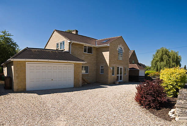 New Home. New build home in the picturesque Cotswolds, gravel drive and clear blue sky on a perfect summers day. gravel stock pictures, royalty-free photos & images