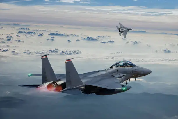 F-15 Eagle Fighter Jets in Flight above the fogy mountains