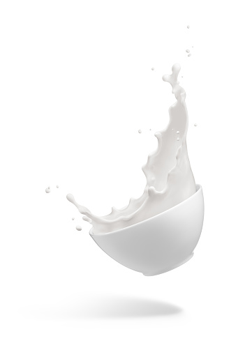 milk splashing out from dropping bowl isolated on white
