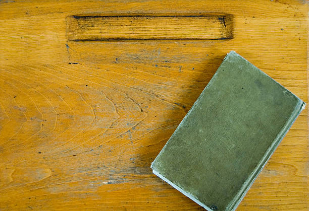 Vintage Wood Desk Top and Green Book with clipping path and copy space