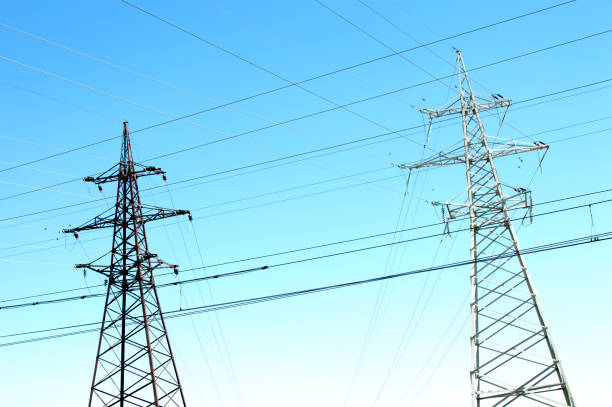 istock Electricity poles with a blue sky on background. Electricity pylons. 1159751880
