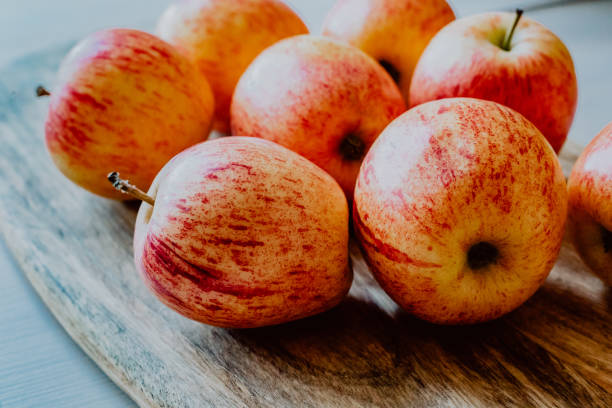 istock red apples on wood 1159753303
