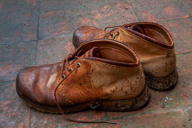 istock Old shoes, used in the fields 1159753356