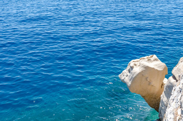 Stone cliff or fancy rock ledge above the blue sea.