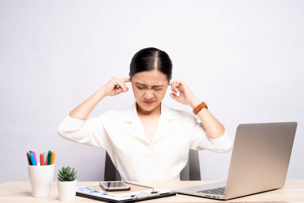 istock Woman putting a finger into her ear at office isolated white background 1159754672