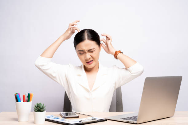 istock Woman scratching her head at office isolated white background 1159754726