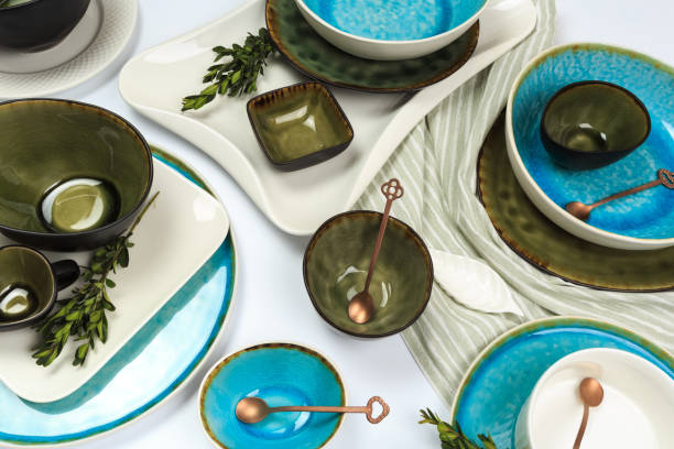istock Simple rustic handmade blue crockery against white wooden wall: dish, stack of bowls. 1159755446