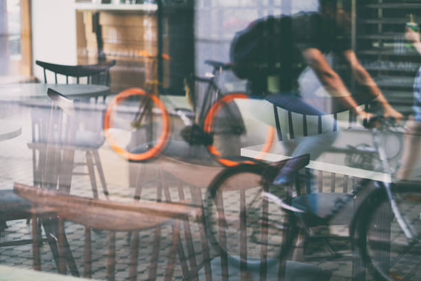 Abstract cafe reality game with chairs and biker reflections in a glass showcase on a street of Riga