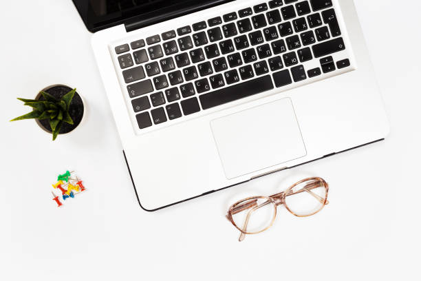 istock Modern workspace with coffee cup, smartphone, paper, notebook, tablet and laptop copy space on white color background. Top view. Flat lay style. 1159755621