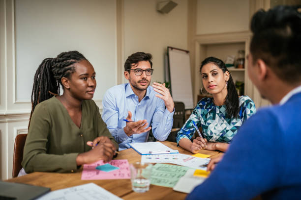 istock Diverse millennial business people having brainstorming in the office 1159757160