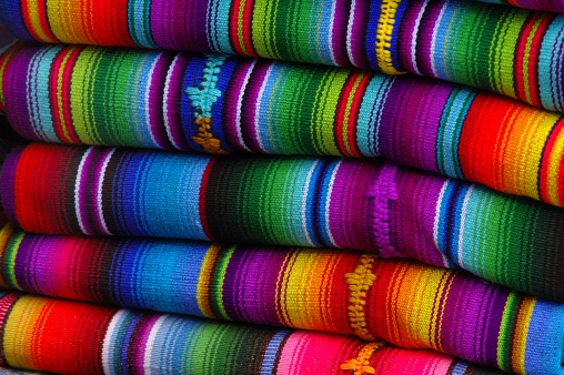 Blanket, Cloth, Fabric, Layered, Stacked, colors, Design, Pattern, Ethnic, Traditional, Mexico, Mexican, Maya, Guatemala, Market, Background, Close Up, Abstract, Blue, Purple, Yellow, Red, Orange, Green, Turquoise, Cotton, Mixed, Craft, Handicraft, Multi Colored, Macro, Horizontal, Pink, Material, Indian, Culture, Folded, Rainbow, Thread, Woven, Wool, Craftwork,  Latin American and Hispanic Ethnicity, Community, Homemade, Texture, Thread, Souvenir, Woven, Collection, Loom
