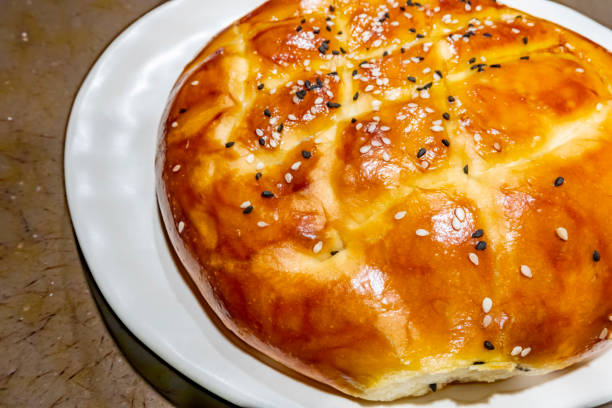 istock close up Turkish ramadan bread, pita bread on white plate with sesames and black seeds 1159761671