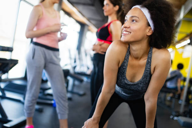 istock Group of young people doing exercises in gym 1159762508