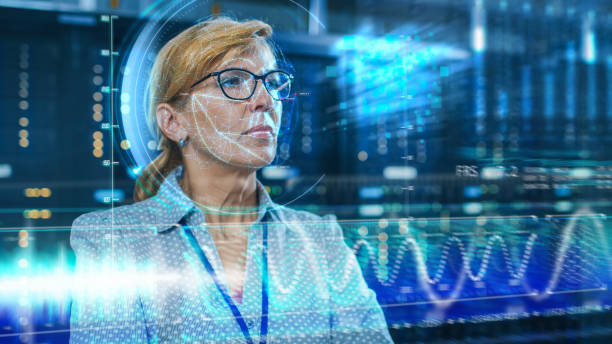 istock Female IT Engineer Identified by Biometric Facial Recognition Scanning Process in Data Center Server Room. Futuristic Concept: Projector Identifies Individual by Illuminating Face by Lines. 1159763173