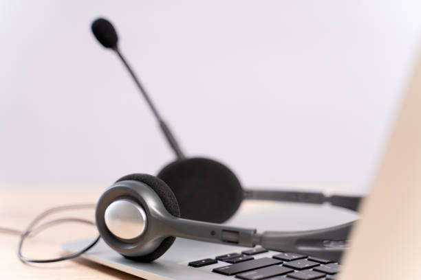istock Headset on keyboard of laptop computer 1159763480