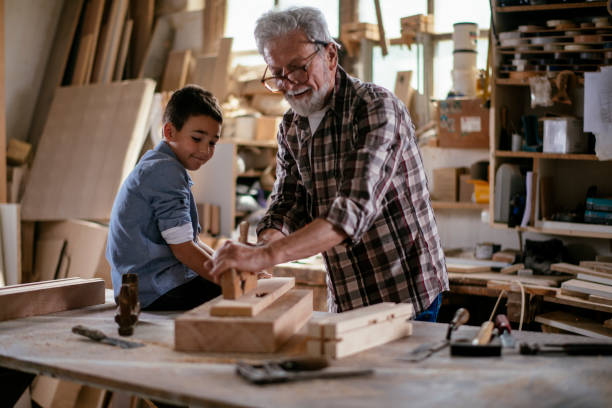 istock Senior carpenter and his grandson having fun in the workshop 1159763798