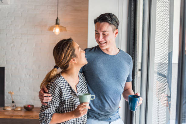 istock Young happy Asian couple at home 1159764939