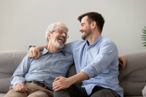 istock Happy grown son sit on couch talk with senior dad 1159765872
