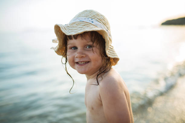istock Two year old girl at seaside in summer 1159766955